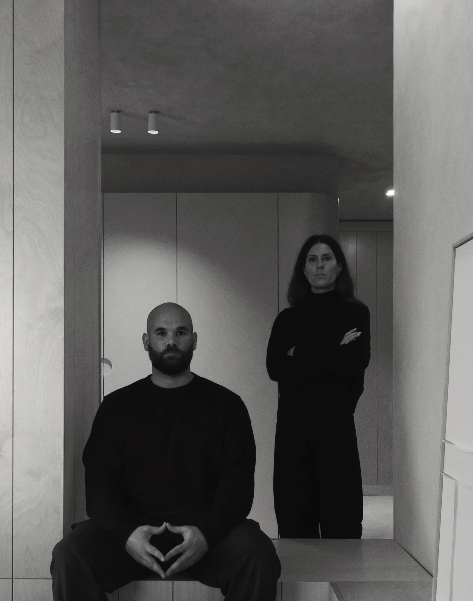 Portrait of the two founders in a light interior